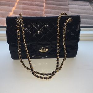 Black purse with gold and black handle